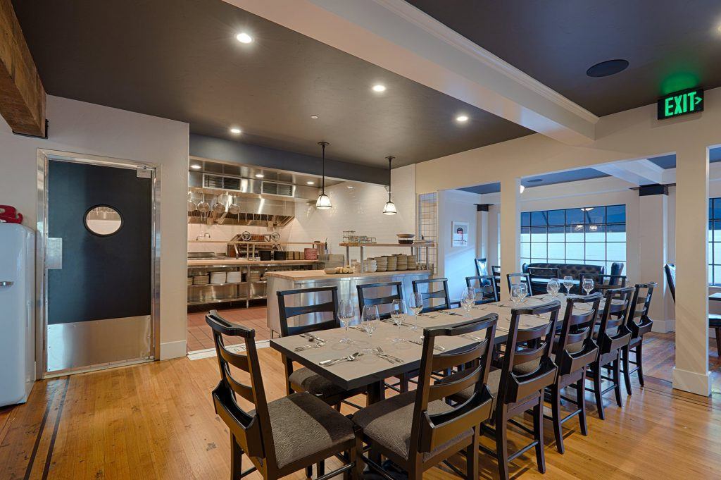 Eating area at Bird and Bottle Restaurant Santa Rosa, with view of open layout kitchen