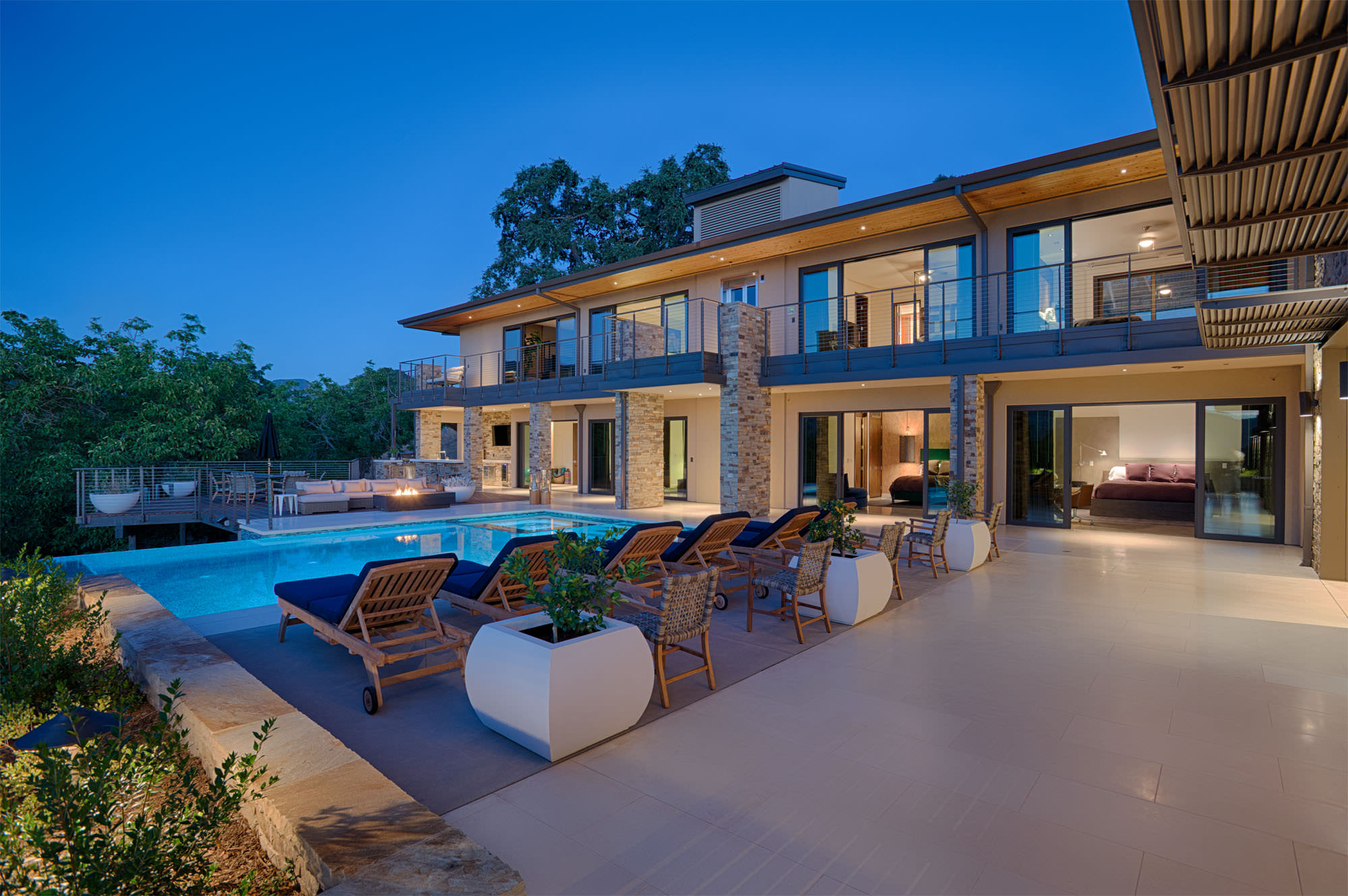 Sun bathing chairs along pool at Oakville hillside residence