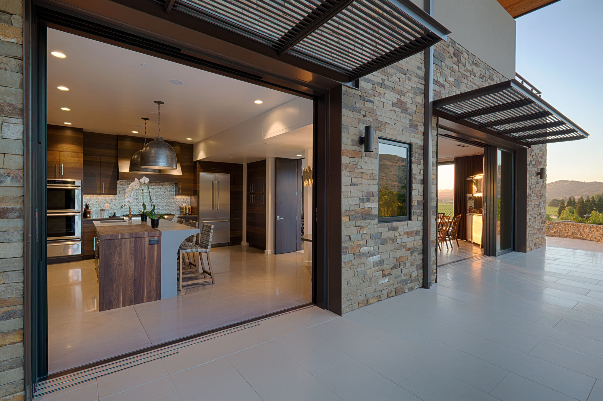 Custom kitchen opening to outdoors at Oakville hillside residence