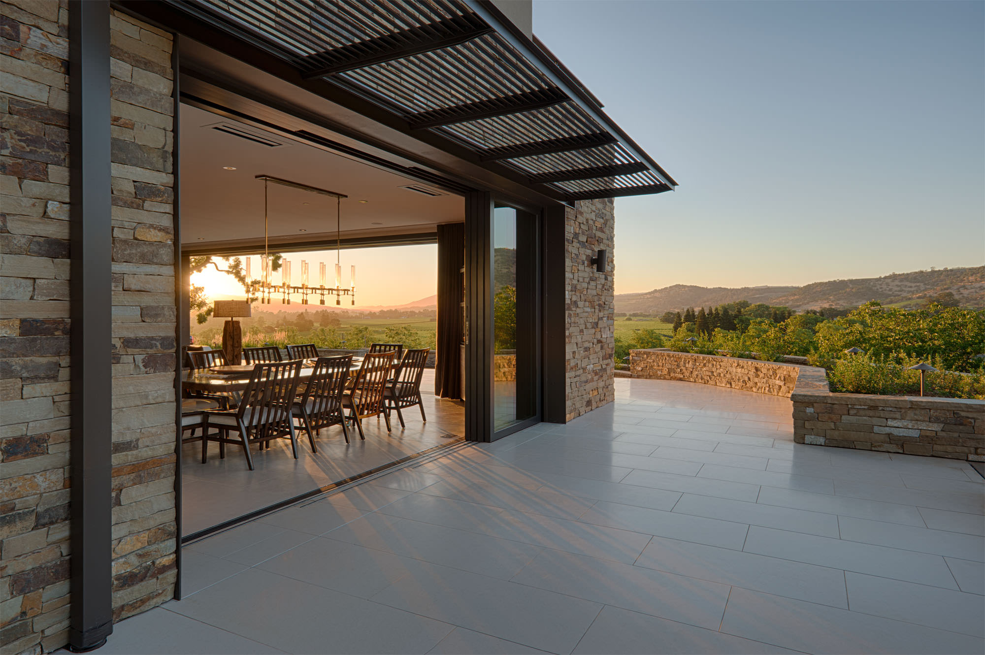 Dining room opening to deck at Oakville hillside residence