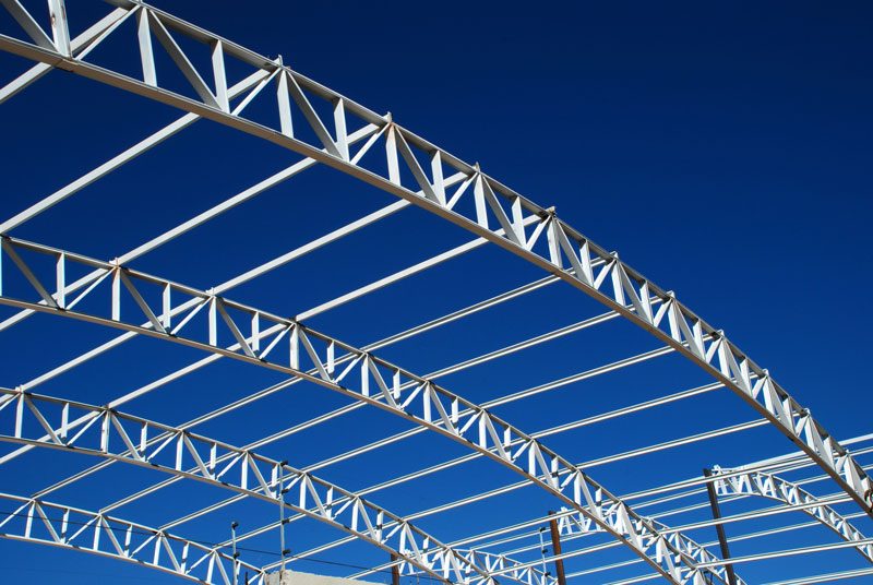pre-engineered metal building construction against blue sky