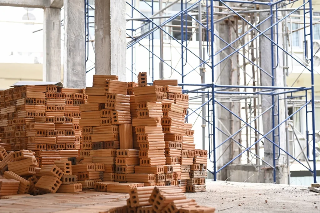 A pile of bricks at a commercial construction site, showing the concept of material procurement